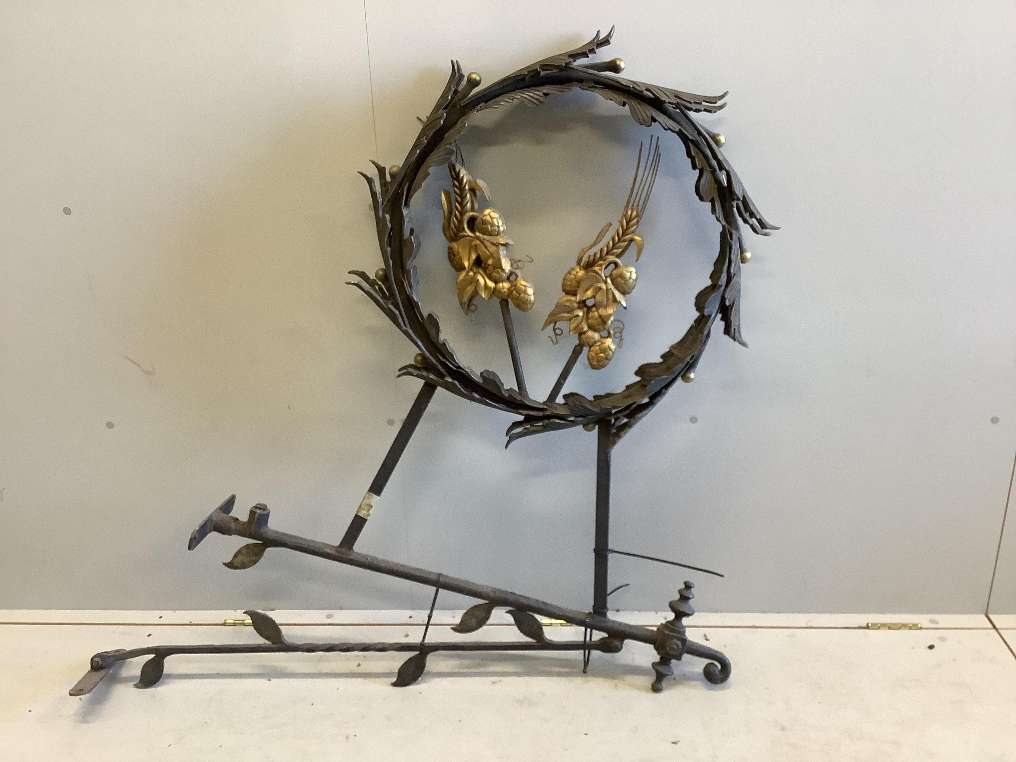 A painted wrought iron parcel gilt hanging wall sign, height 120cm